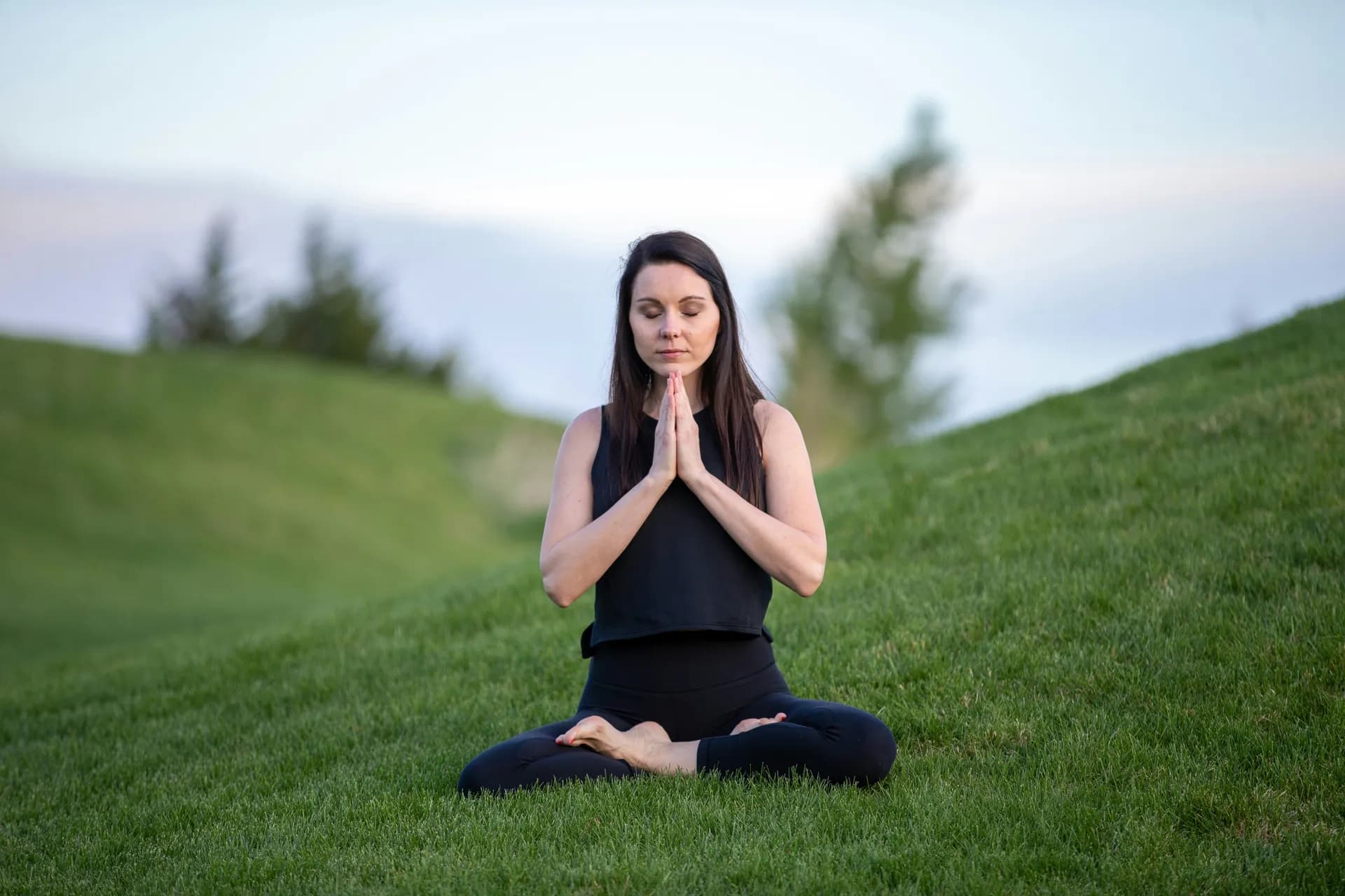 Una mujer meditando en una esplanada
